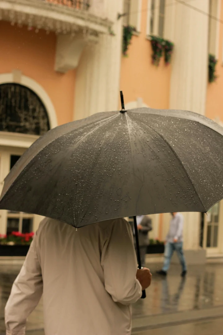 An umbrella in a rainy street